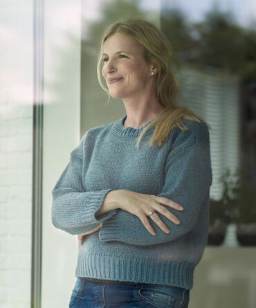 A woman looking outside a Window