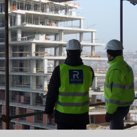 Construction professionals looking out on building project.