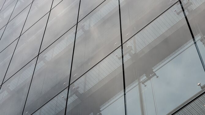 Detail of large glass façade on office building.